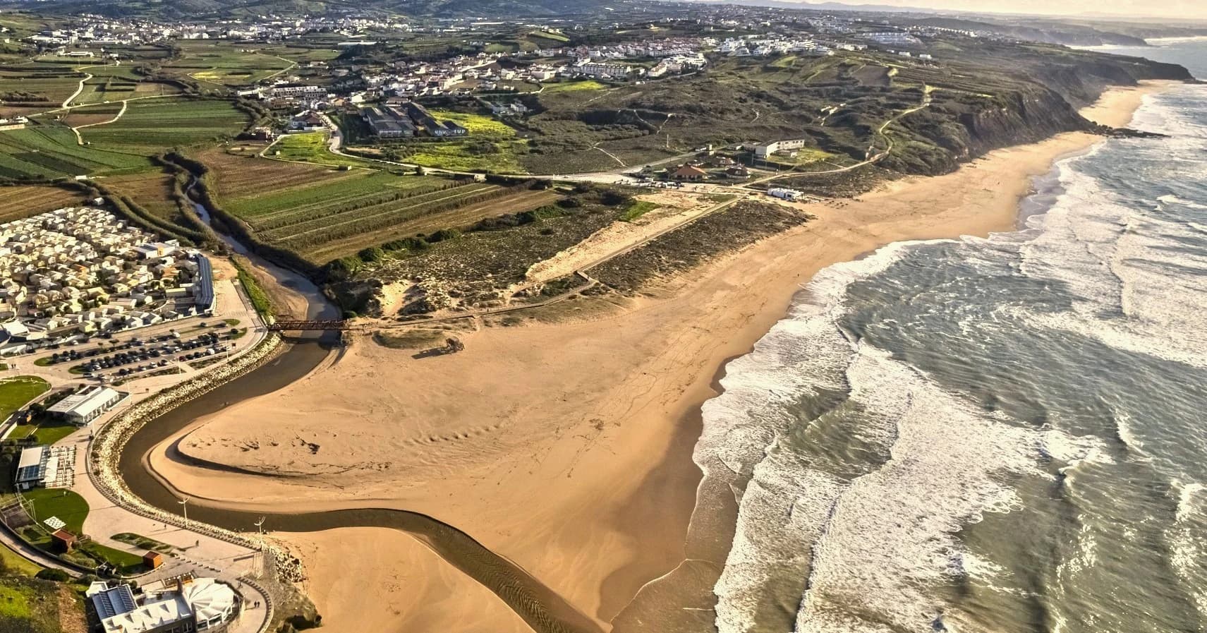 Aerial view of Praia da Areia Branca and its sandy Atlantic coastline in Lourinhã, Portugal